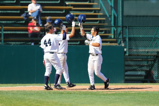 Ramon Bramasco (right) is greeted by teammates after his two-run home run