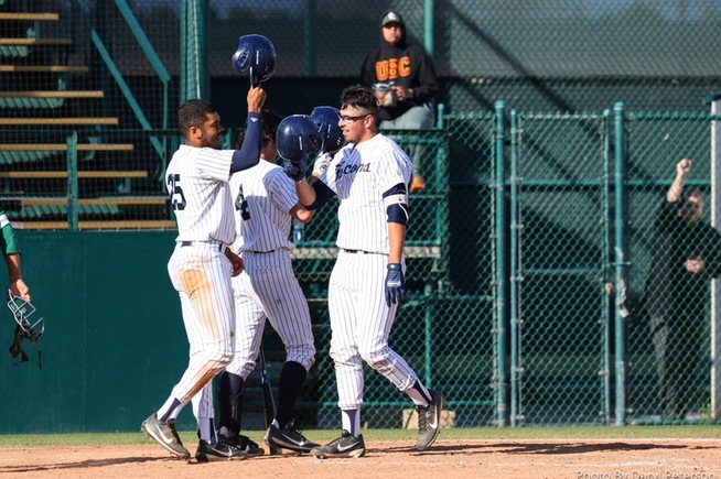 Roberto Salazar (right) is greeted by Michael Gonzalez (left) after his two-run home run