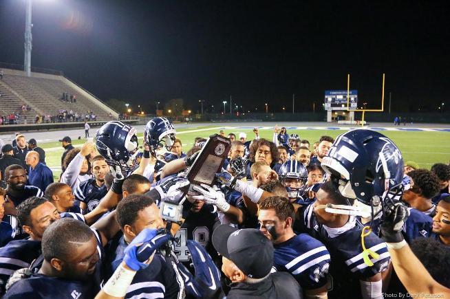 The Cerritos football team celebrates after winning the Golden State Bowl title