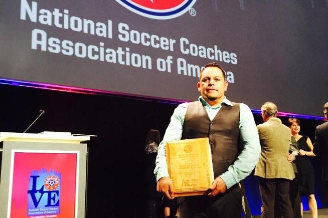 Benny Artiaga receiving his National Coach of the Year award