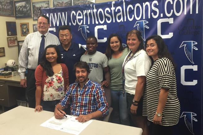 Agustin Lombardi (seated) signs with Northern Colorado University