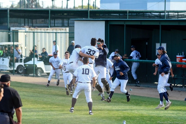 Andre Alvarez (33) is mobbed after scoring the winning run on a wild pitch