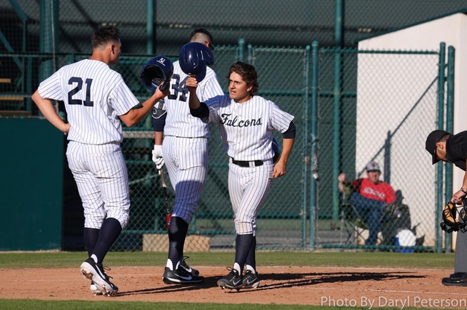 Alex Bueno (R) is congratulated after his two-run home run in the third inning
