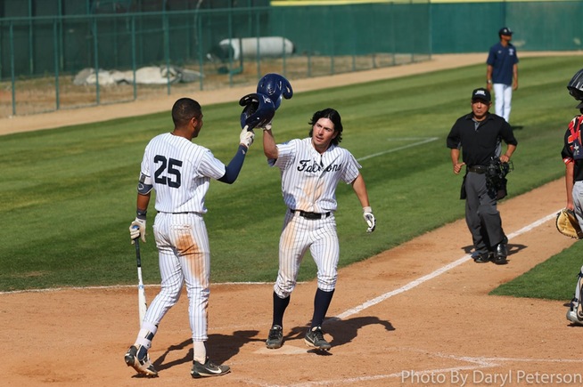 Trevor McInerney is greeted by Michael Gonzalez after hitting his second home run of the game