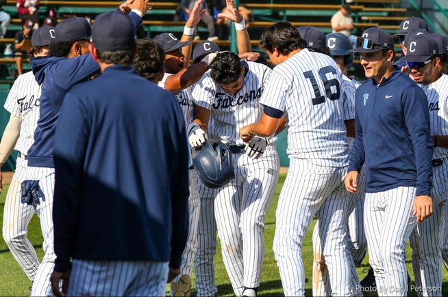 Mike Santos is greeted by teammates, including starting pitcher Derek Valdez (16), after hitting his second home run of the day