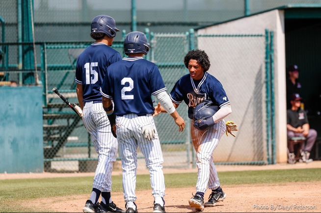 DJ Massey is met at home plate by Juan Garcia (15) and Nico Briones (2) after scoring in the Falcons 5-1 win
