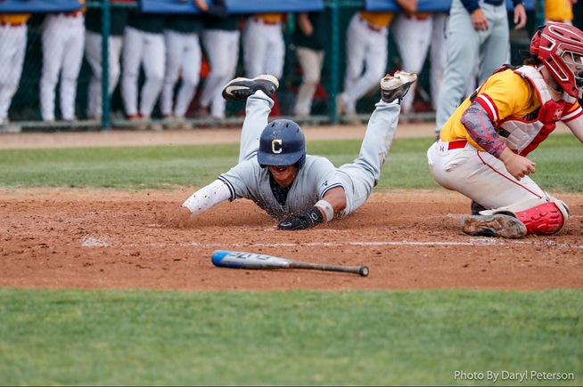 Dylan Immel scores on a wild pitch for the Falcons