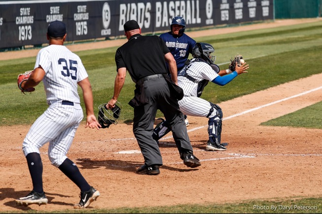 Ryan Reyes tags out Josh Sotelo at the plate with Franky Lopez (35) backing up the play