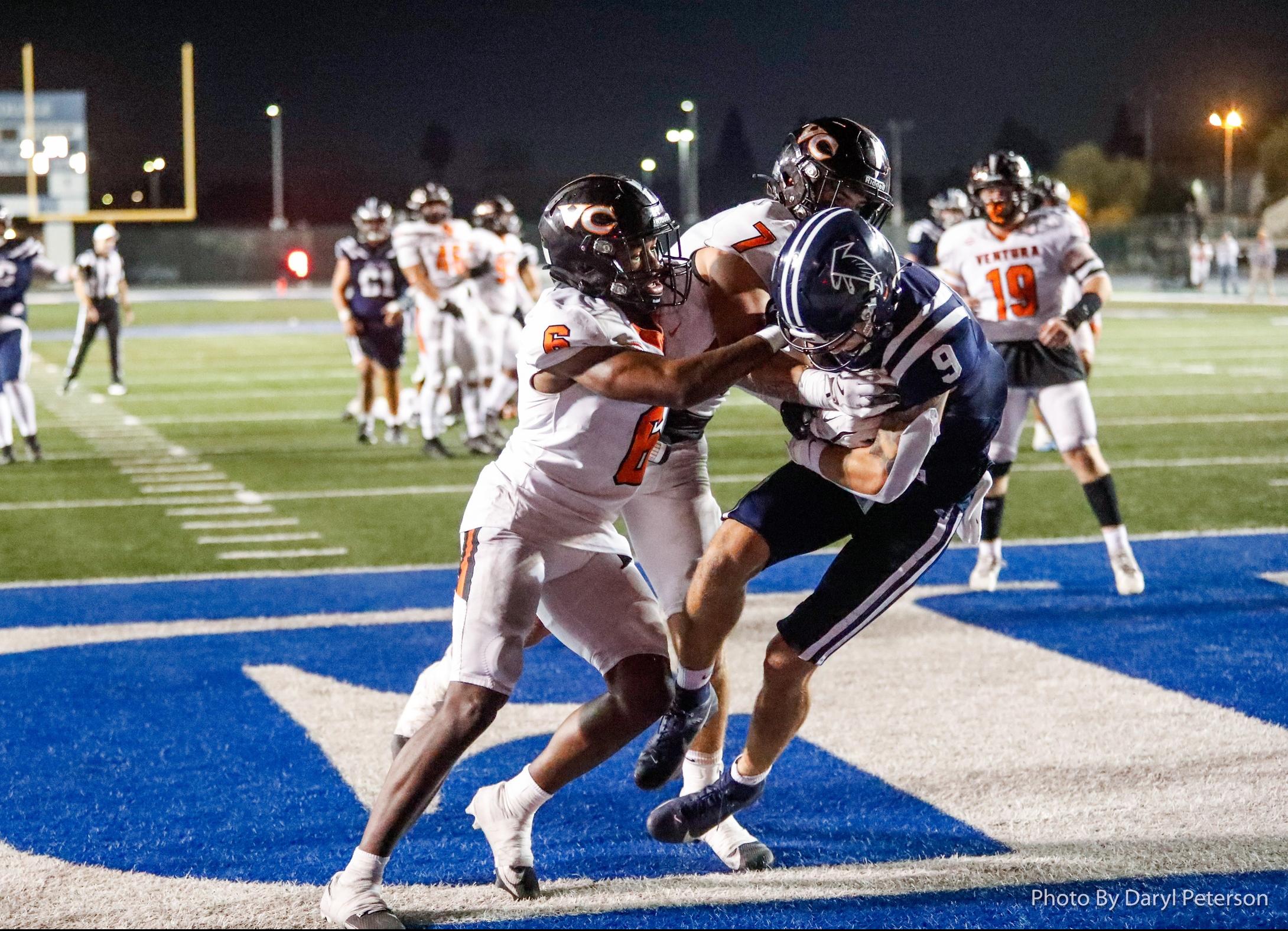 Owen Tomich (9) catches one of his three touchdown passes on the night