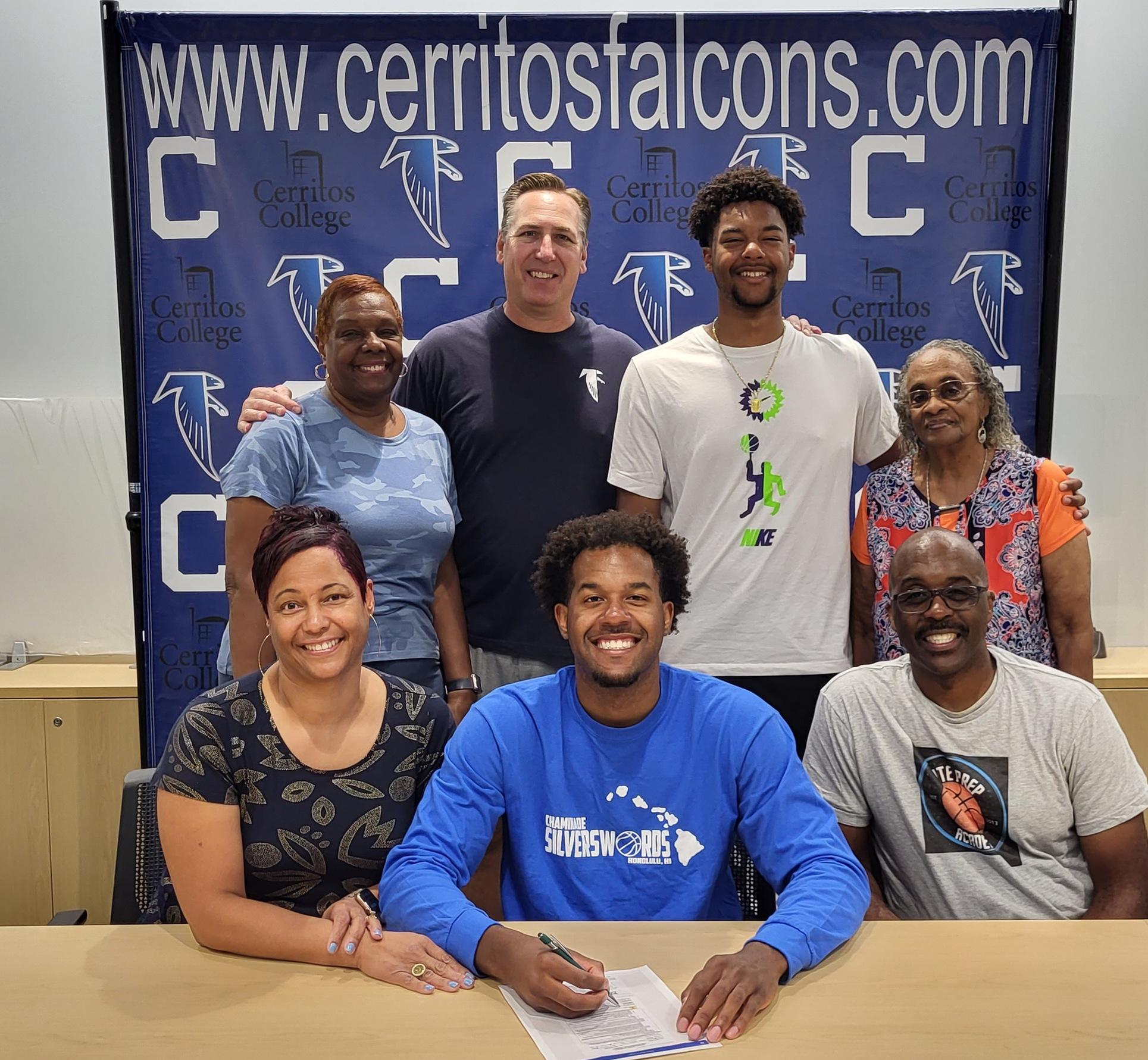 Dorian Harris is joined by family and head coach Russ May, as he signs his scholarship paperwork with Chaminade (HI) University.