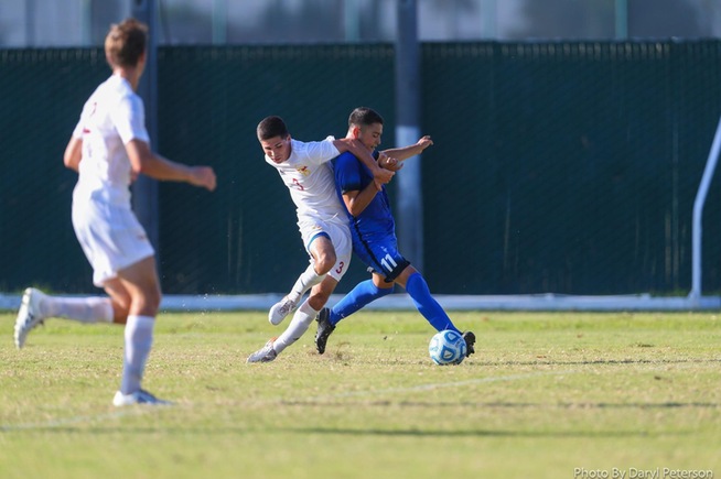 Bryan Villalobos battles with a Desert player for the ball in the Falcons 2-0 win