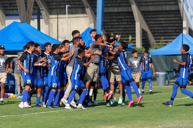 The Falcons swarm Michael Rodriguez (22) after his first of two goals against Imperial Valley College