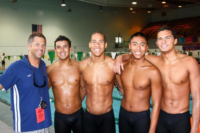 (L-R) Head Coach Joe Abing is joined by Marcus Delgado, Joshua Owens, Eugene Runas and Nathan Umpornpuckdi after they set a new school record in the 400-yard medley relay.