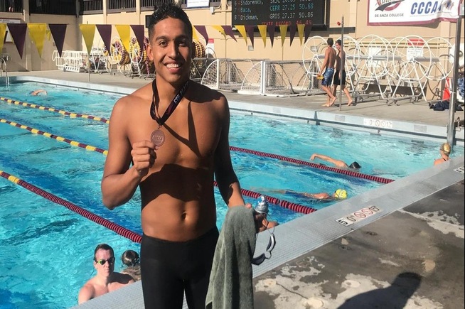 Rodrigo Baca with his sixth place medal from the 100-yard butterfly