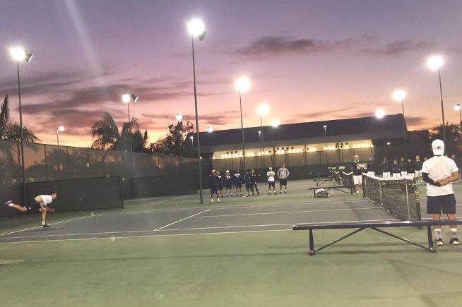 Members of the Falcon men's tennis team watch on in their loss to Irvine Valley