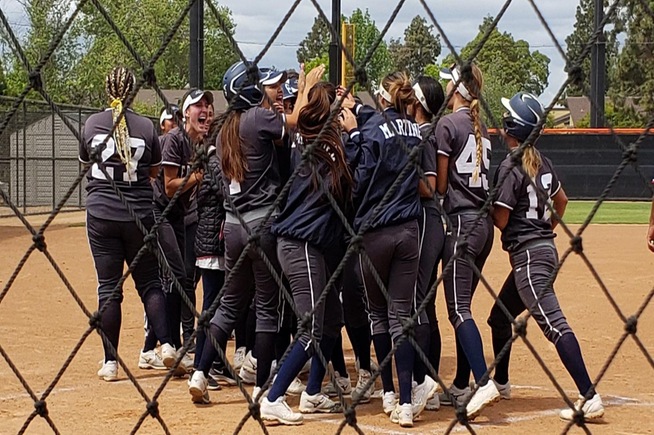 The Falcons meet Victoria Medina at home plate after her two-run home run