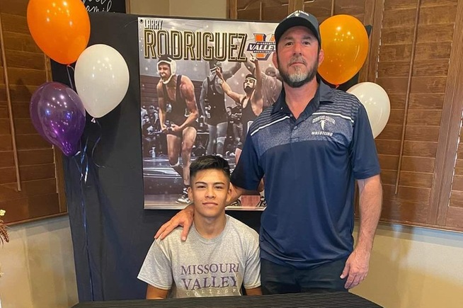Wrestling head coach Donny Garriott joins All-American Larry Rodriguez, who signed with Missouri Valley College