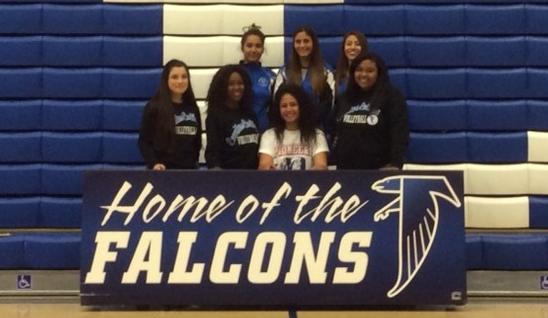 Jasmynne Roberts is surrounded by teammates after signing her NLI