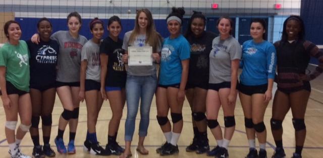 Sara Hickman (center) is joined by members of the Falcon volleyball team