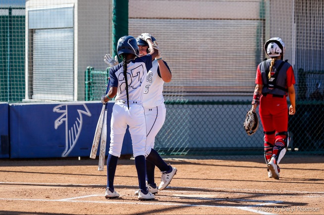 Brooklyn Bedolla is greeted by Negasse Williams (27) after her home run