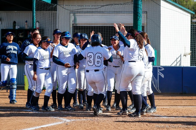 Jimena Velazquez is greeted at home plate after her two-run home run