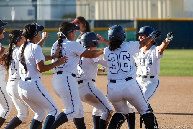 Falcons celebrate with Marley Manalo (9), who drove in the game-winning run against Mt. San Antonio