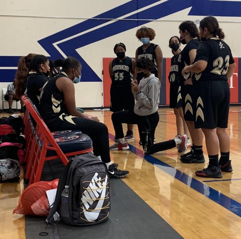 New head coach Adria Jackson talks over the game plan with her Bellflower High team at a recent practice